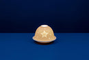 A white unglazed porcelain tealight holder with a dome cover featuring a lithophane star design, displayed against a blue background.
